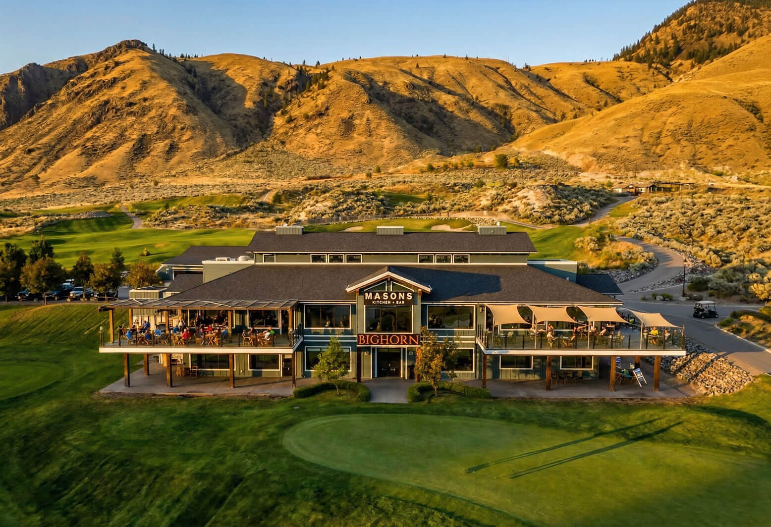 Bighorn Golf clubhouse and Mason’s Kitchen & Bar patio with mountain views in Kamloops